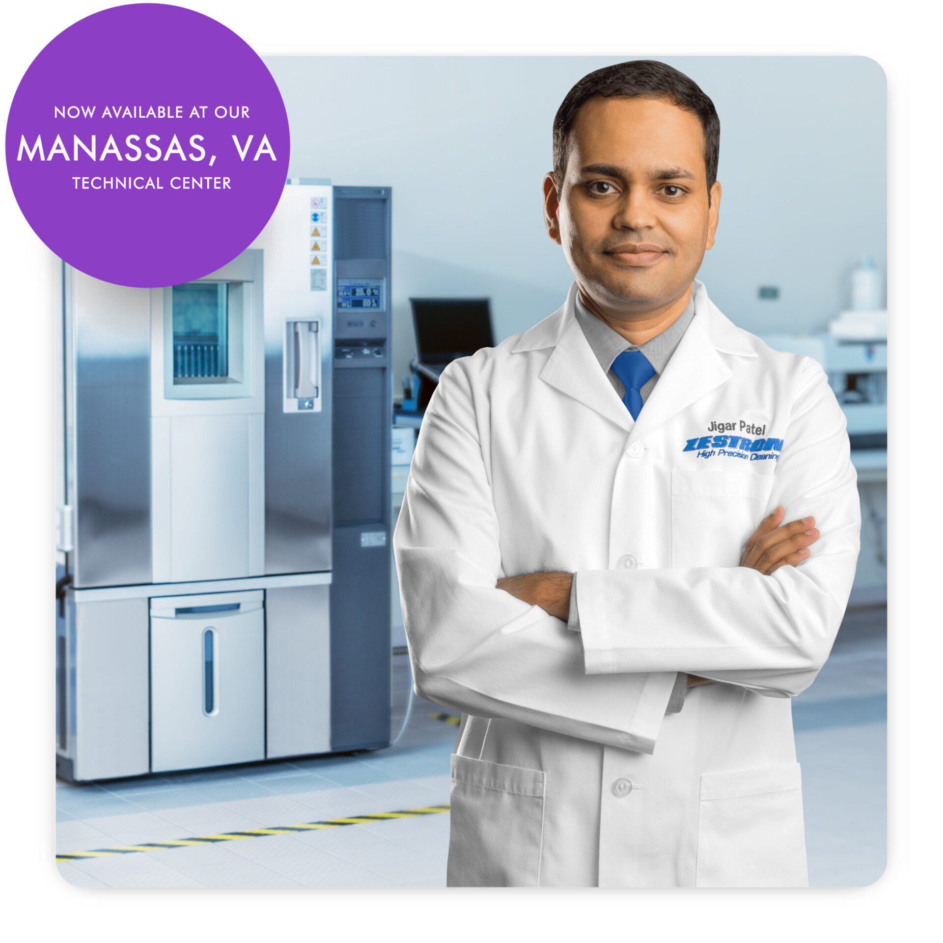 Jigar Patel - Senior Application Engineer at Zestron in front of sir machine 