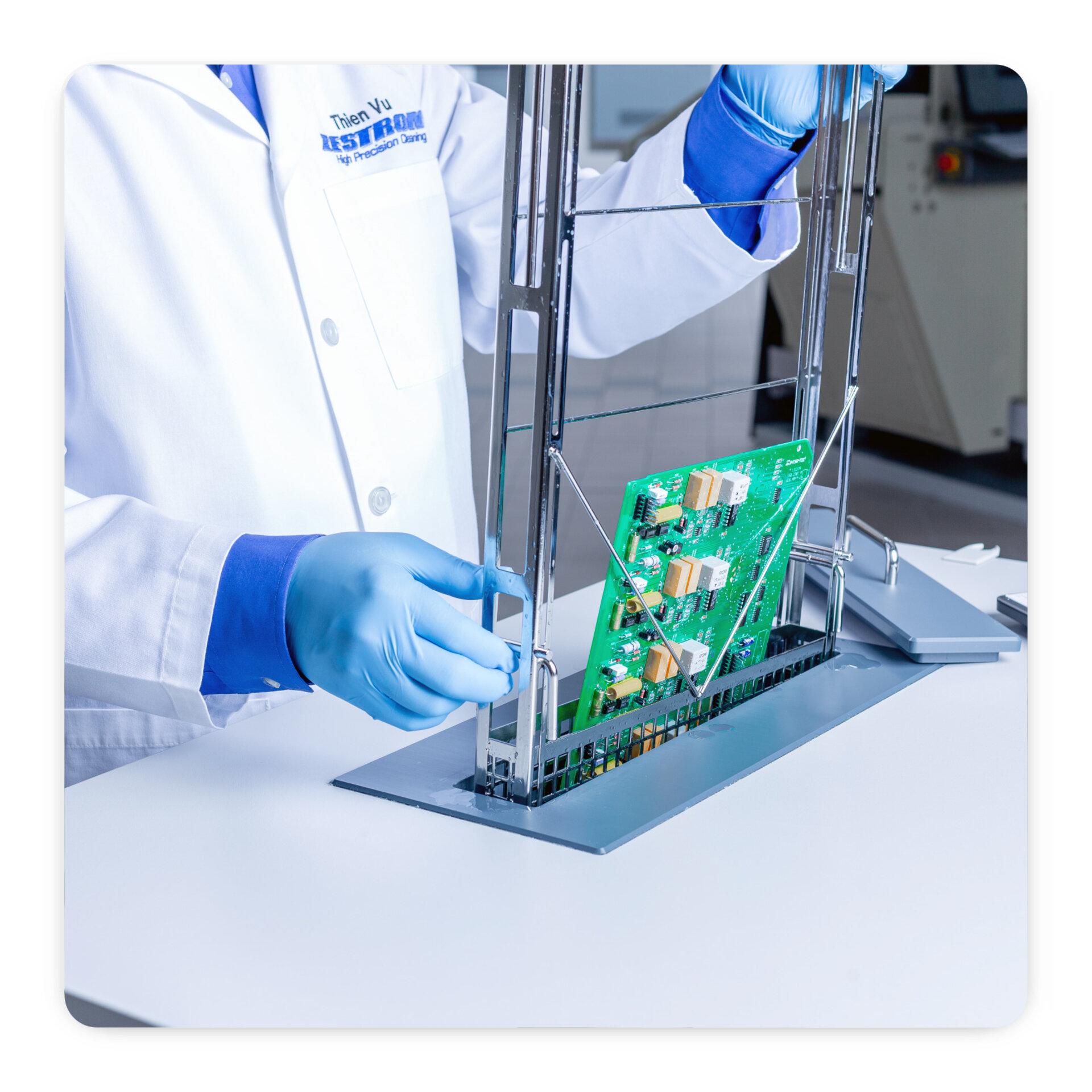 engineer dipping pcb into ionic contamination machine for testing 