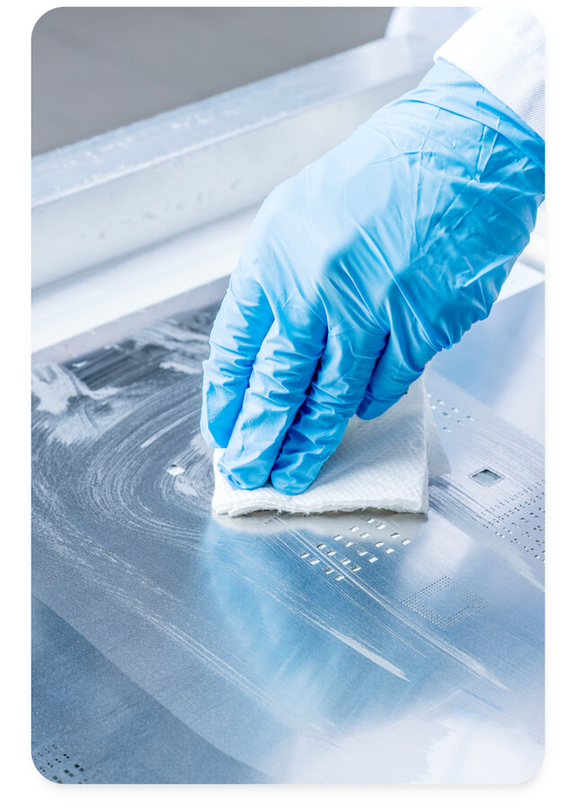 engineer using stencil cleaning wipes to clean openings 