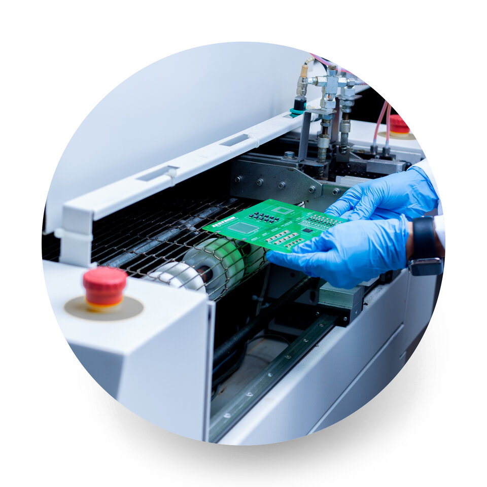 engineer putting pcb into reflow oven